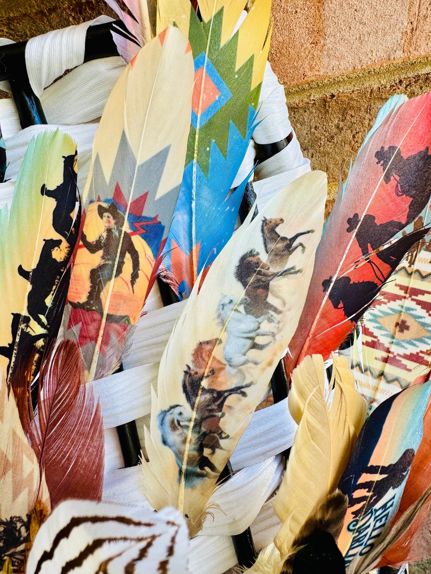 Decorative feathers with artistic designs on a textured surface