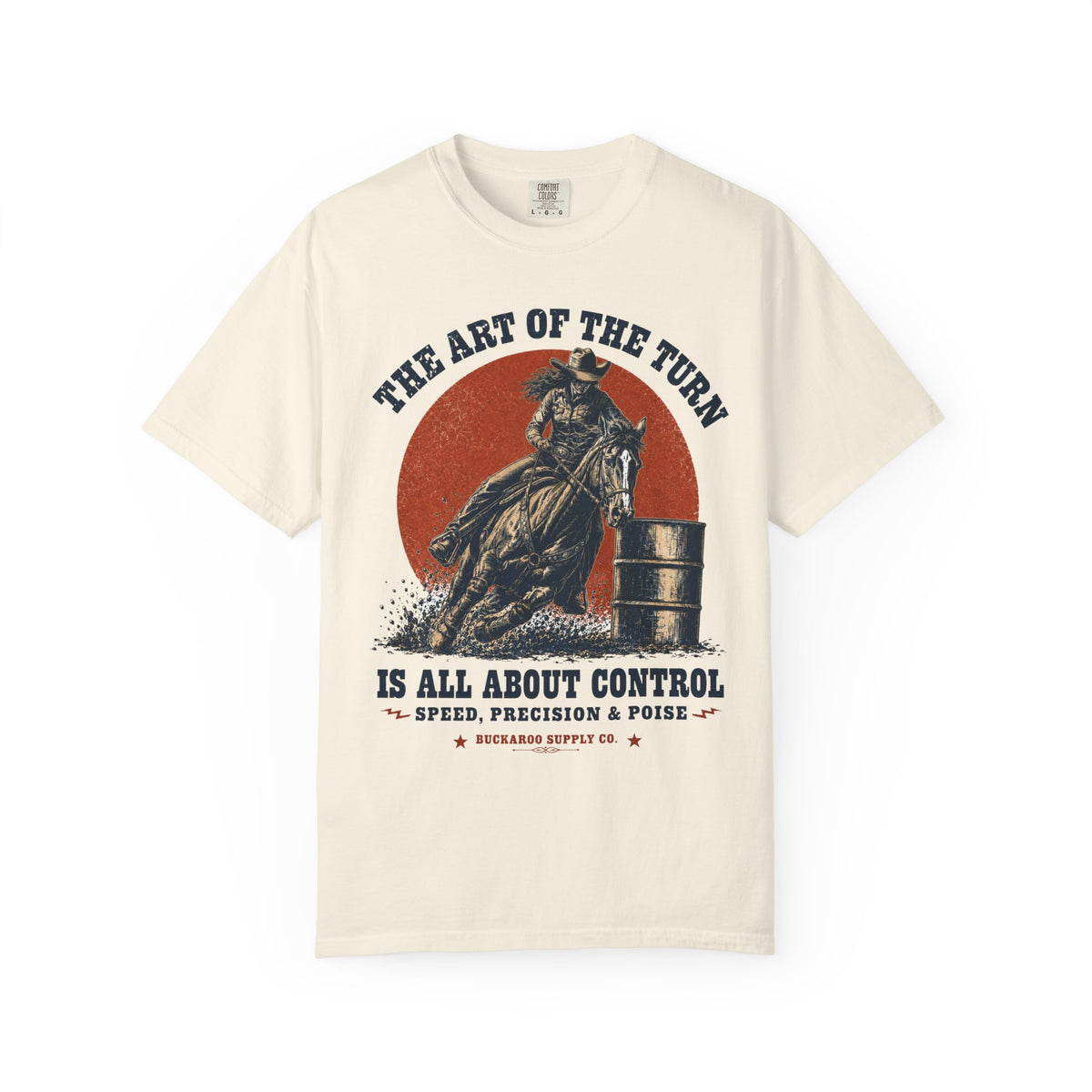 An off-white short-sleeve t-shirt with a vintage-style graphic of a cowboy riding a horse in front of a red sun, with the text 'THE ART OF THE TURN IS ALL ABOUT CONTROL' and 'BUCKAROO SUPPLY CO.'