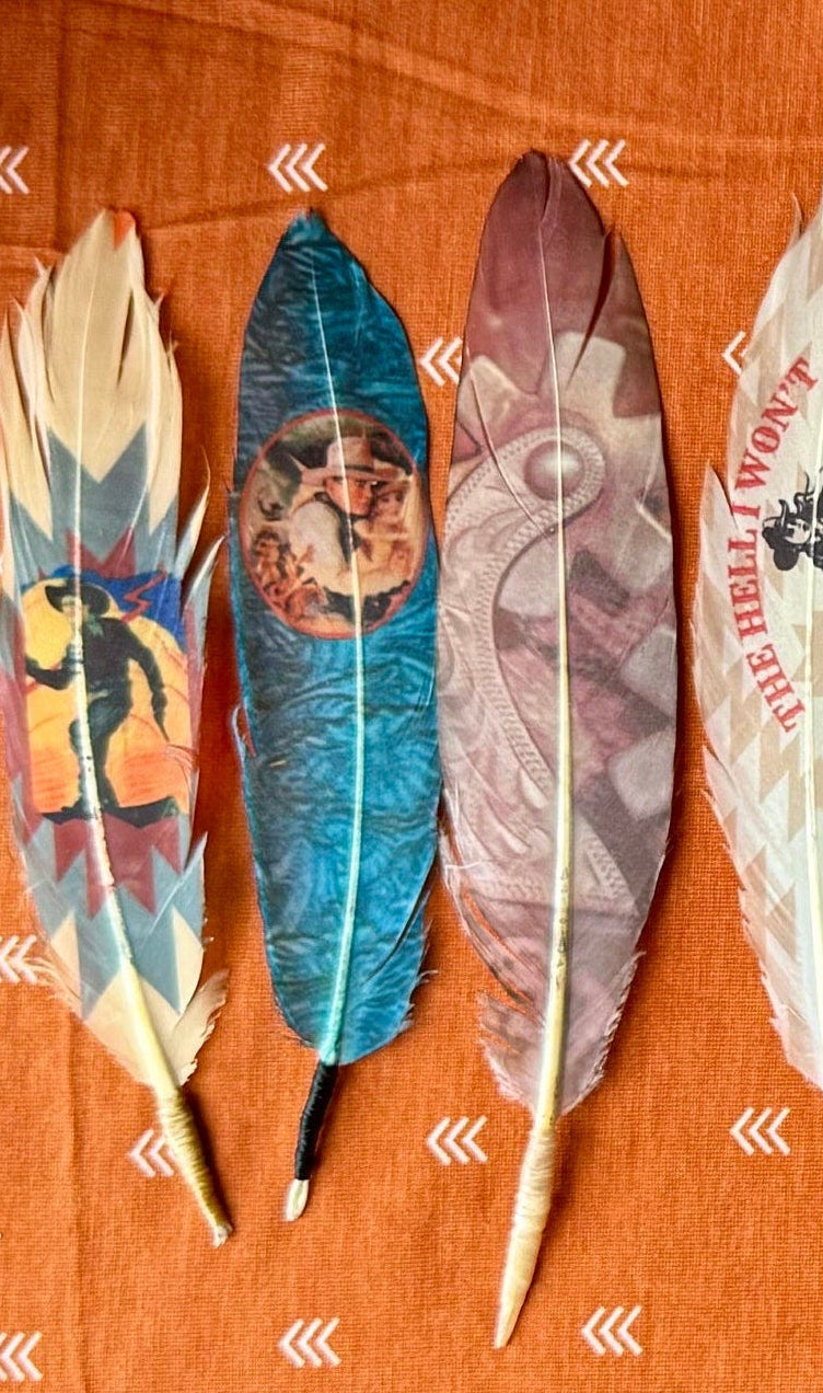 Decorative feathers with various patterns on an orange fabric background