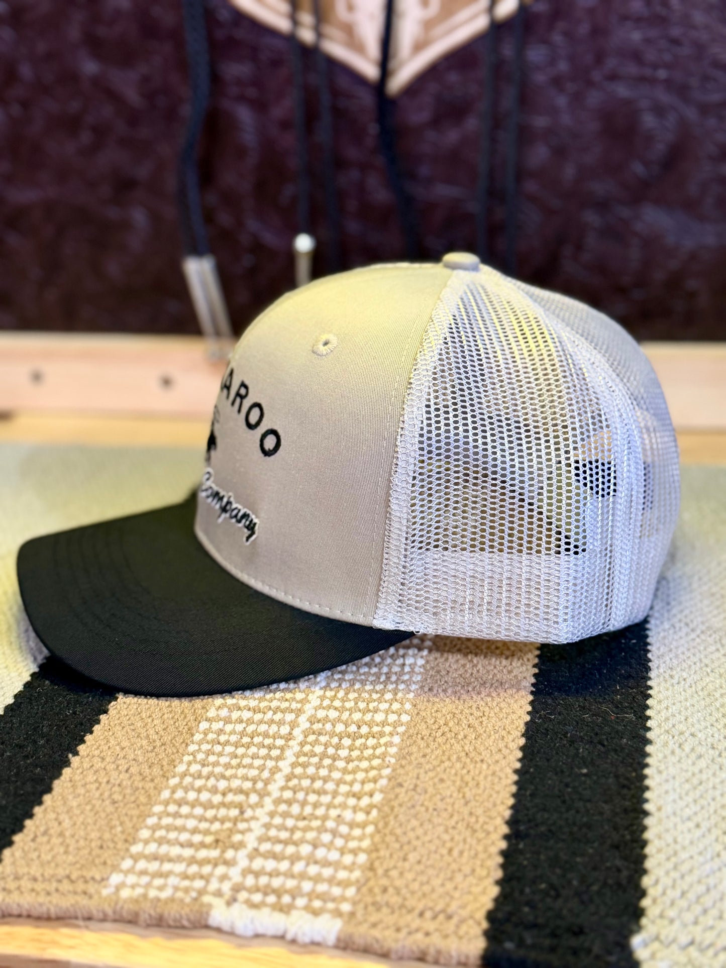 Side view of tan mesh back on Buckaroo tan and black trucker hat