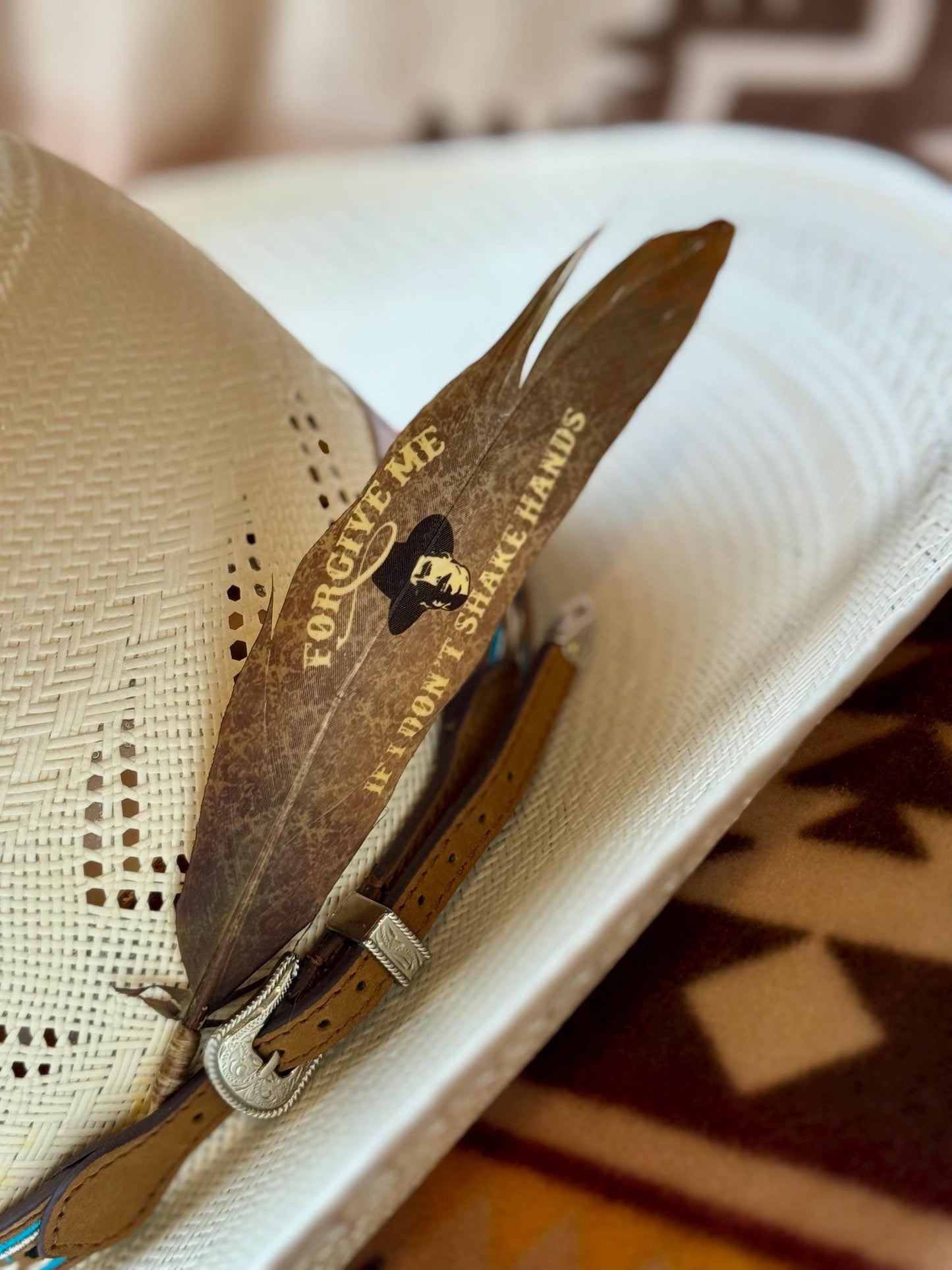 Forgive Me Western hat feather on a white straw cowboy hat
