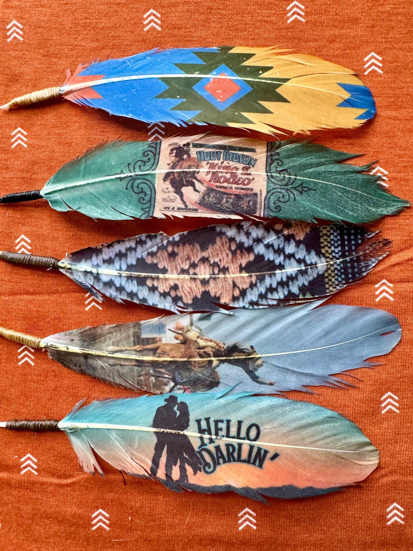 Decorative feathers with various designs and text on an orange background