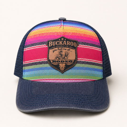 Colorful serape striped trucker hat with a Buckaroo Supply Co logo on a white background.