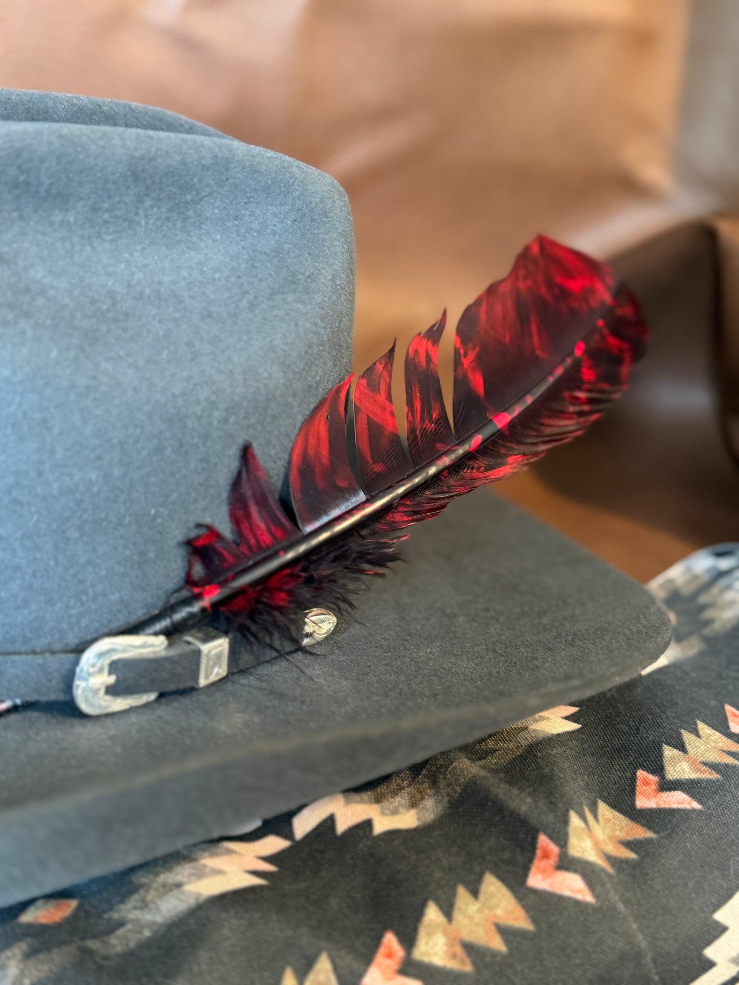 Red and black marbled Western hat feather by Buckaroo Supply Co.