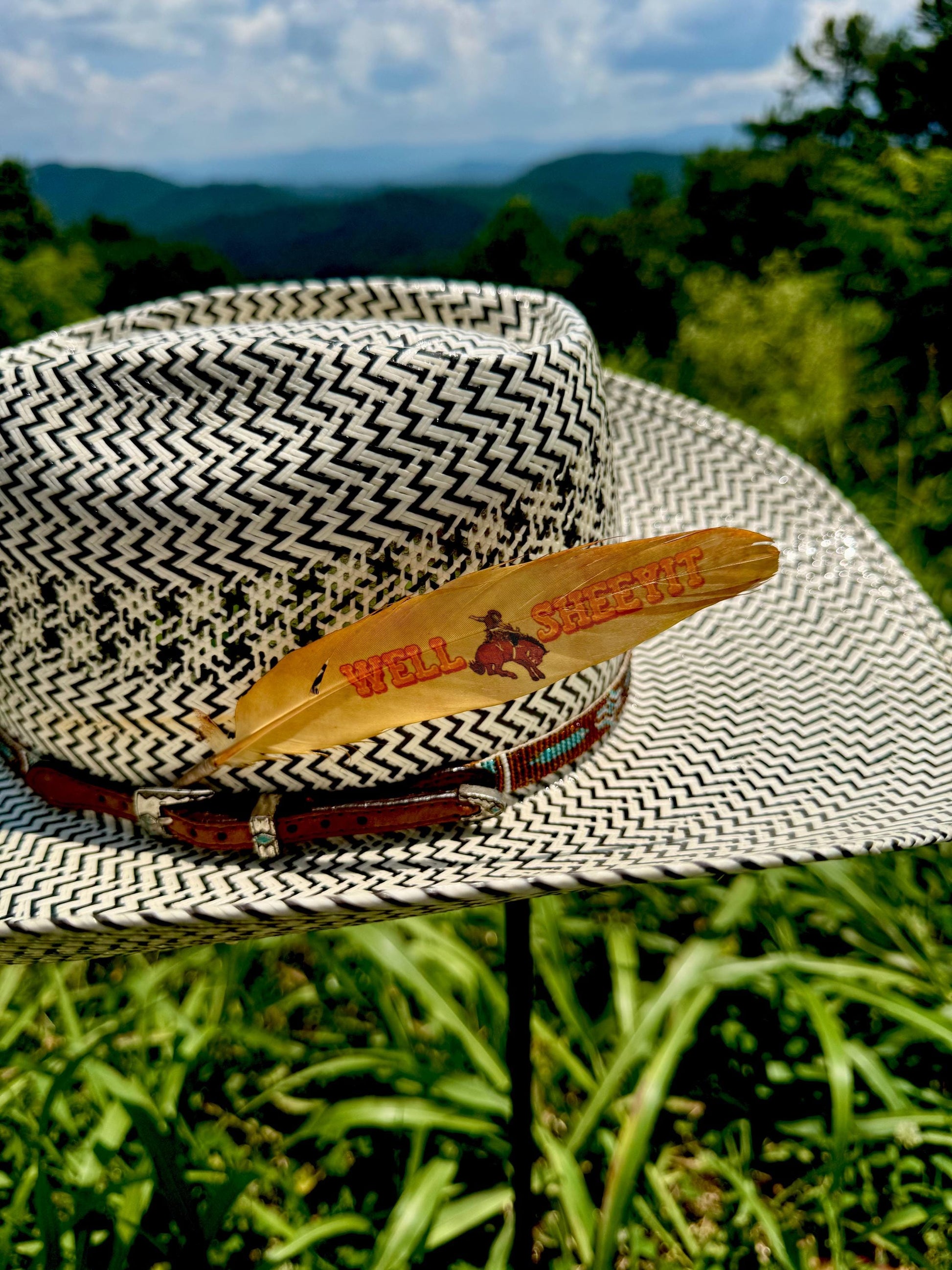 Orange bronc rider cowboy hat feather by Buckaroo Supply Co.