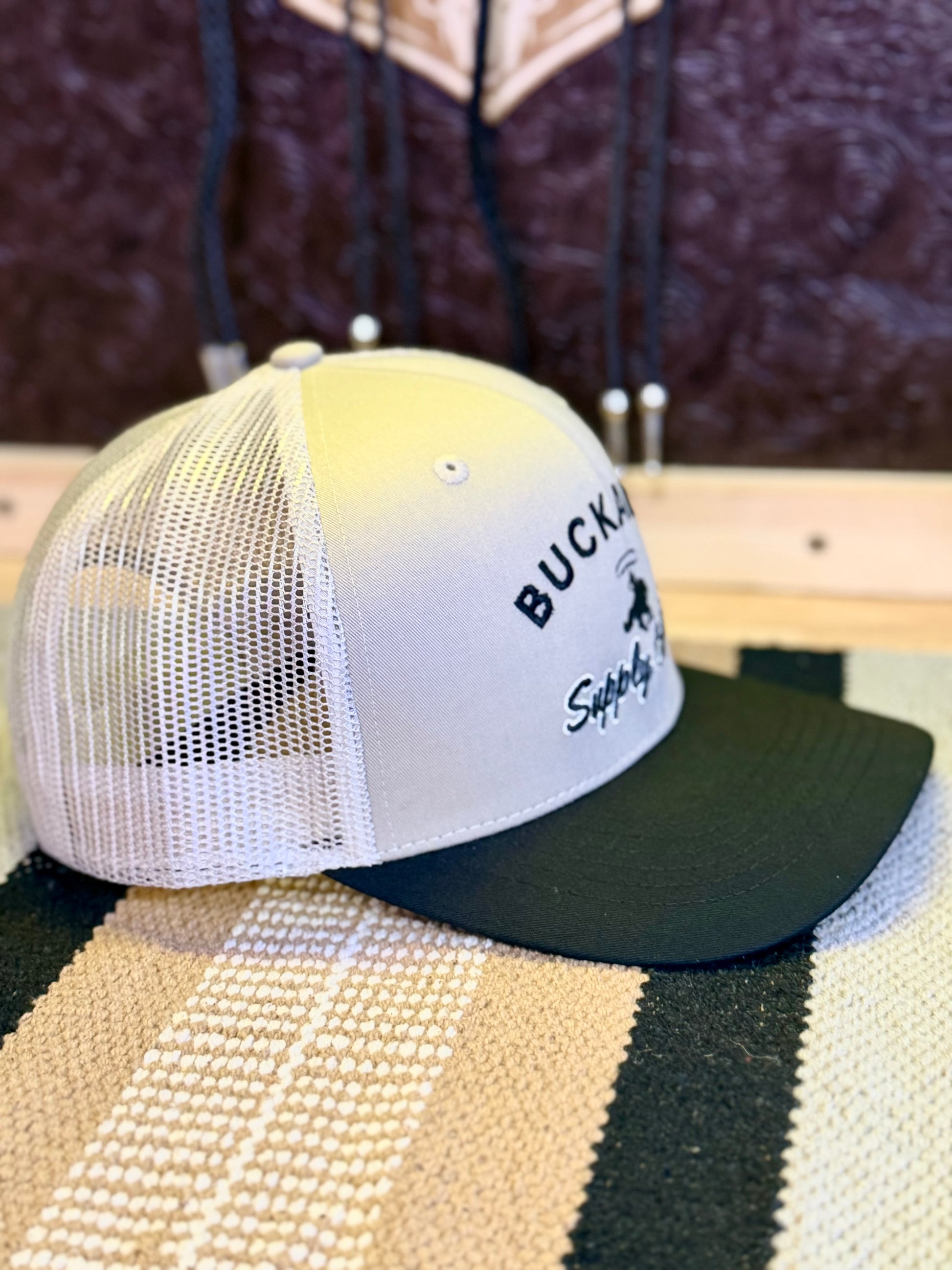 Side view of tan mesh back on Buckaroo tan and black trucker hat