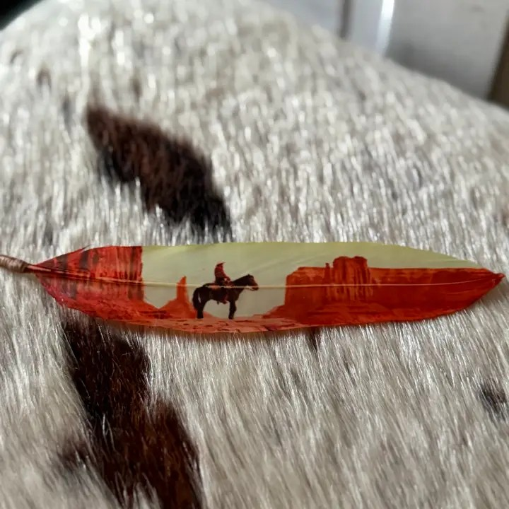 Desert Cowboy hat feather with Western desert artwork in warm red and cream tones