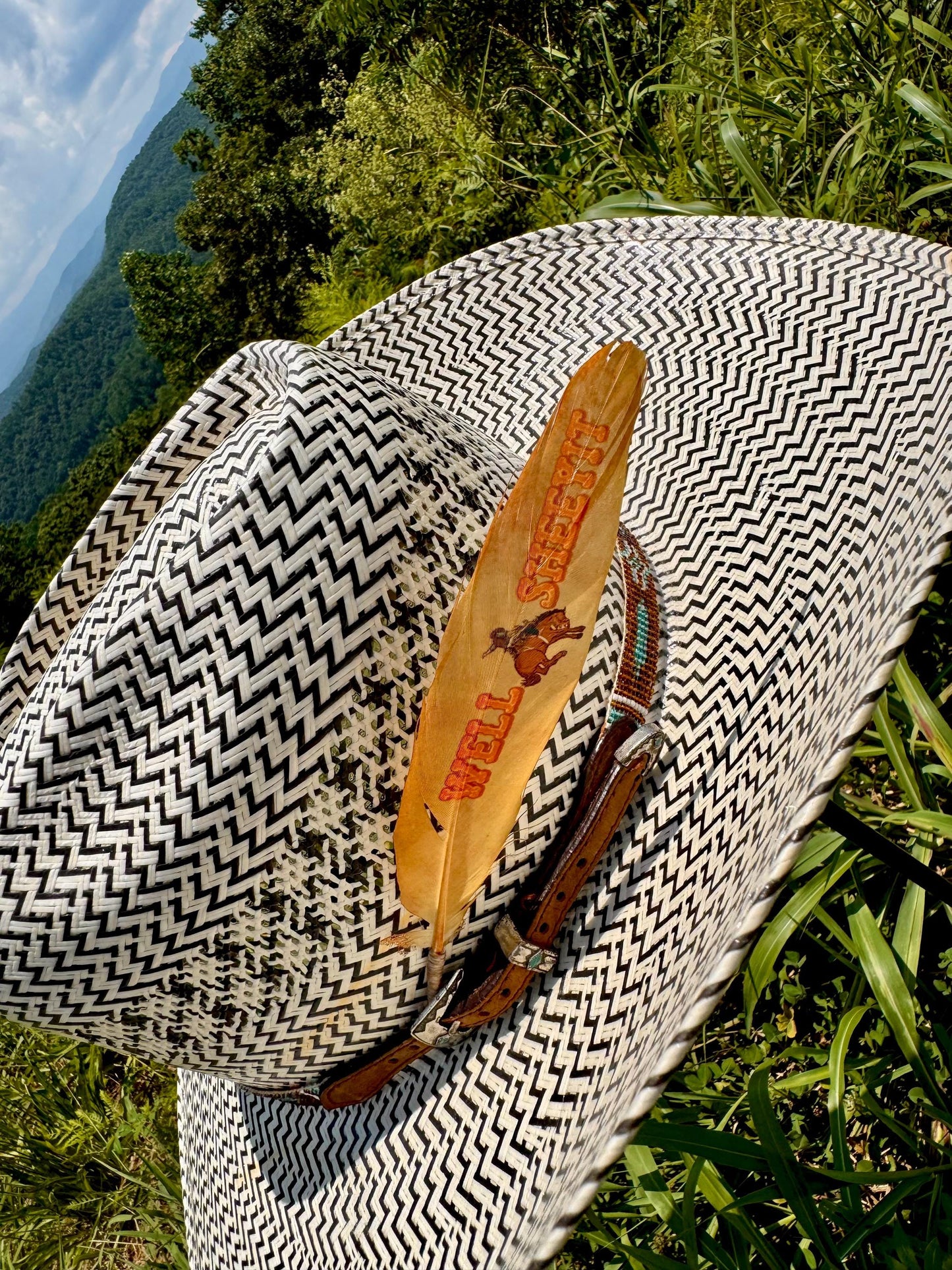 Orange bronc rider cowboy hat feather by Buckaroo Supply Co.
