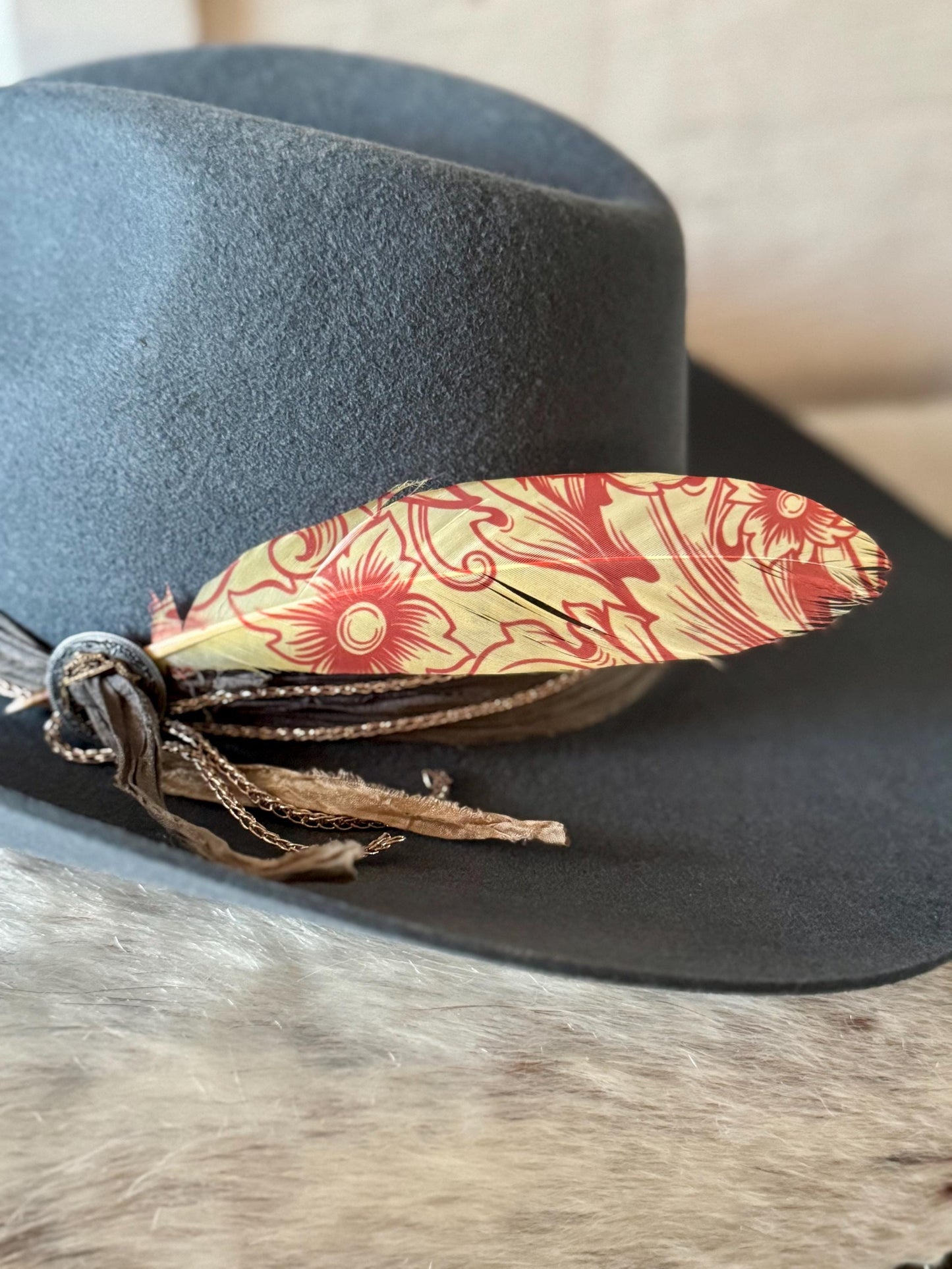 Buckaroo Supply Co. floral Western hat feather in warm red and cream tones