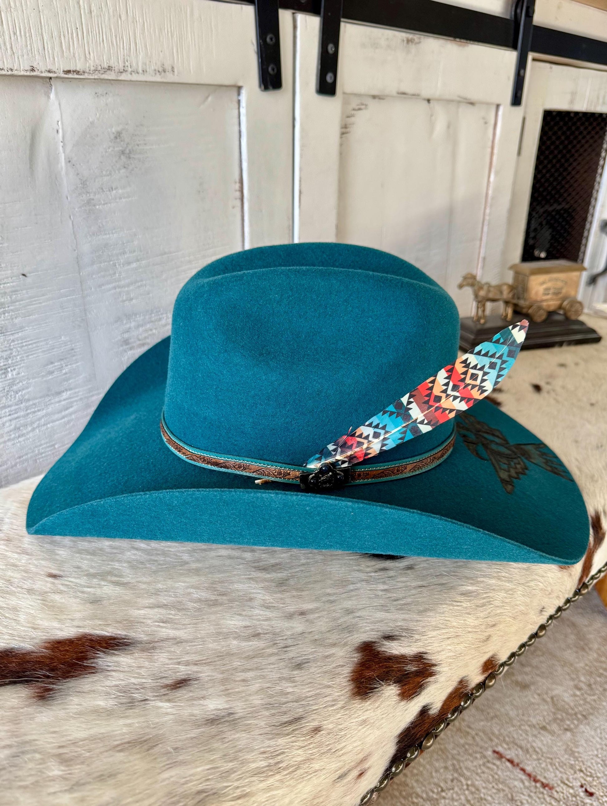 Southwestern geometric cowboy hat feather with turquoise and coral tones