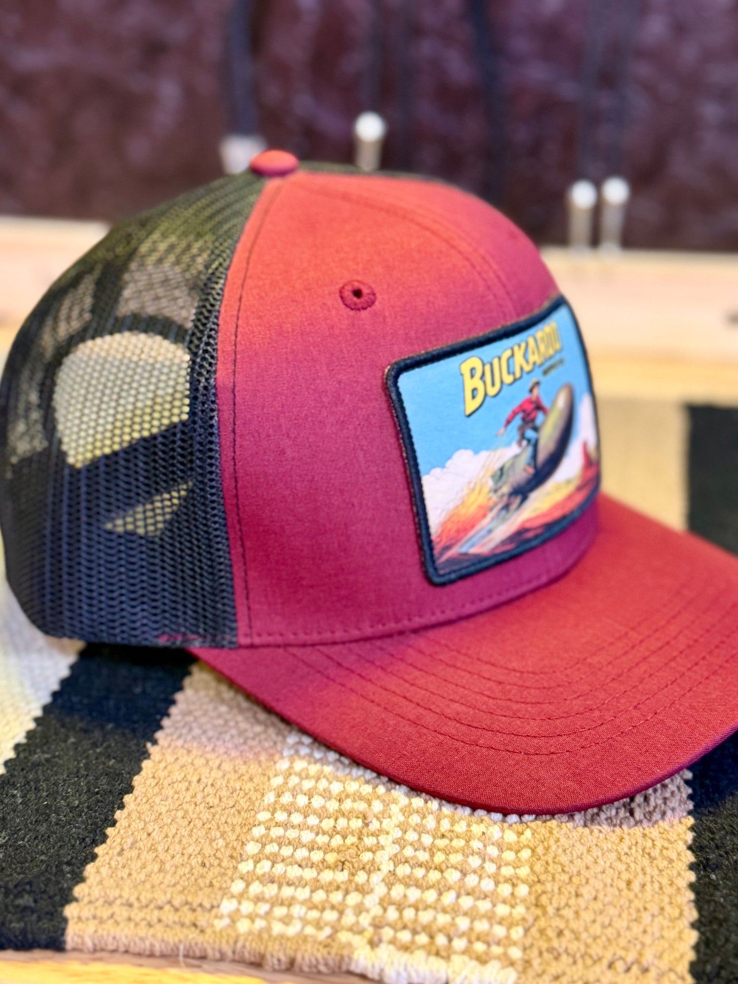 Wine and black mesh-back Western trucker hat with Atomic Buckaroo patch