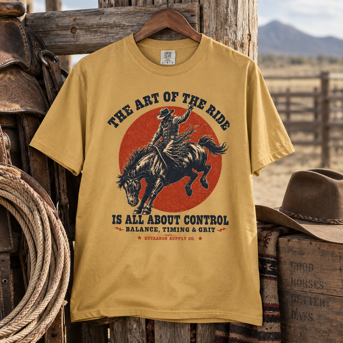 Mustard bronc rider Western graphic T-shirt displayed in a rustic ranch setting