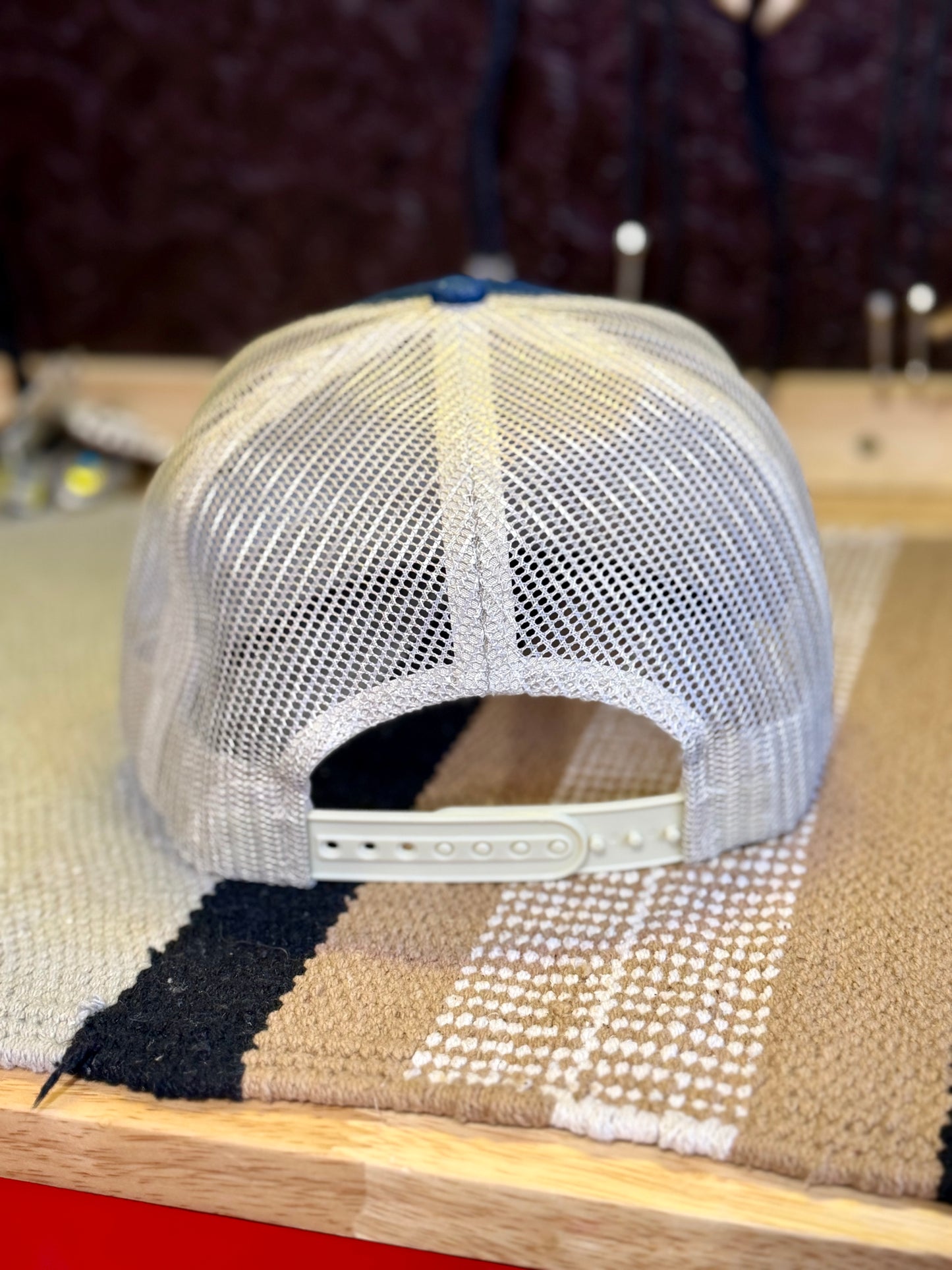 Back view of denim and cream mesh Western trucker hat with snapback closure