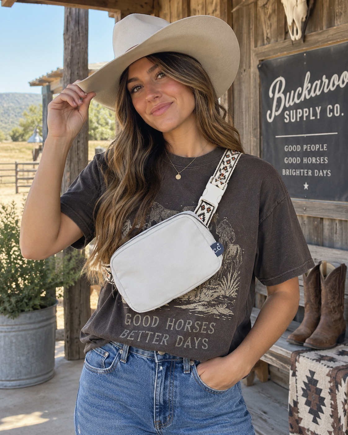 Cowgirl wearing white Western belt bag crossbody with Southwestern patterned strap