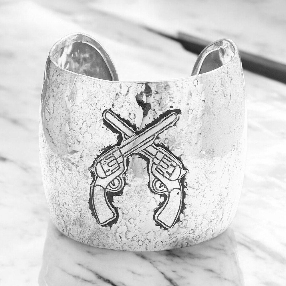 Silver hammered metal cuff bracelet with crossed revolver design