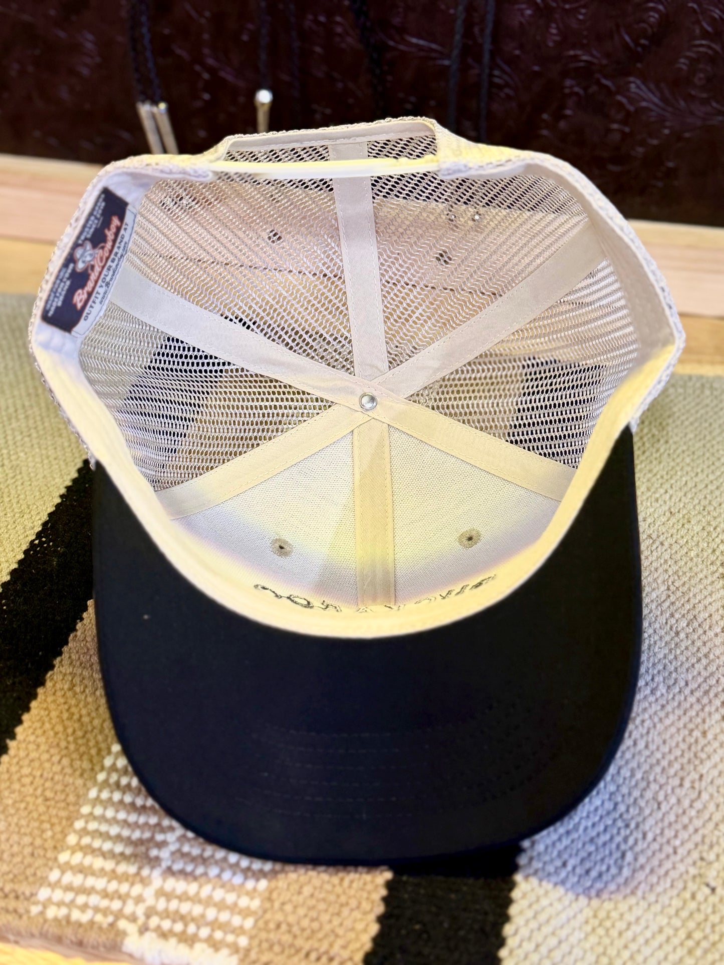 Back view of tan mesh Western trucker hat with adjustable snapback closure