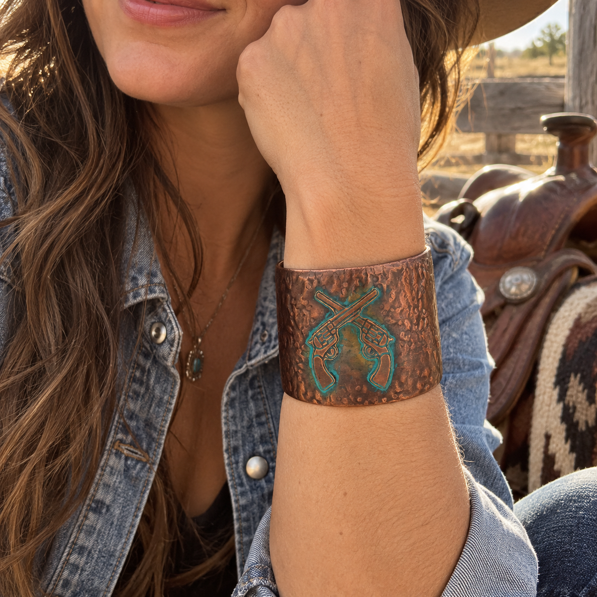 Cowgirl wearing burnished copper crossed revolvers Western cuff bracelet