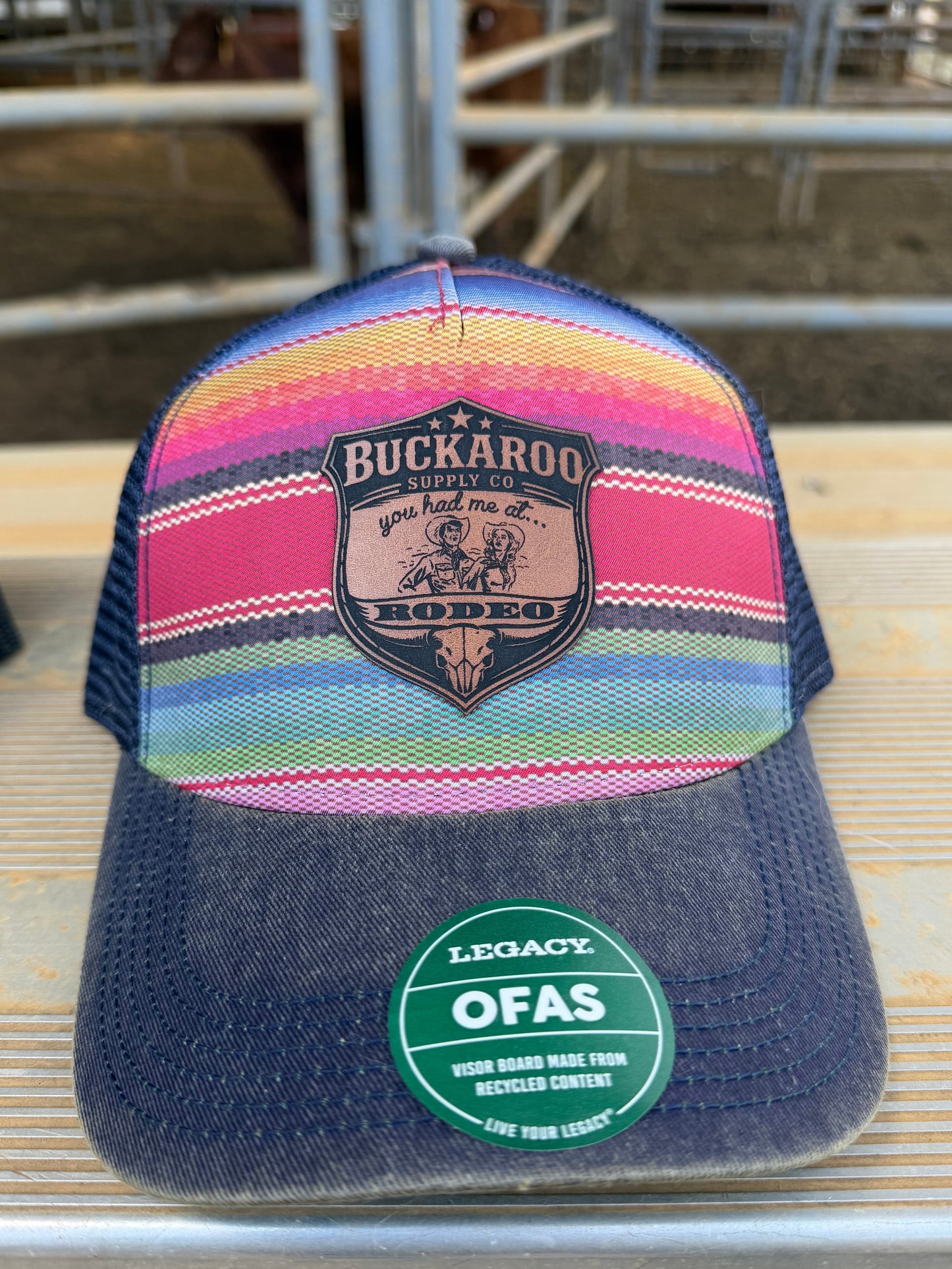 Colorful trucker hat with a brand logo on a wooden surface