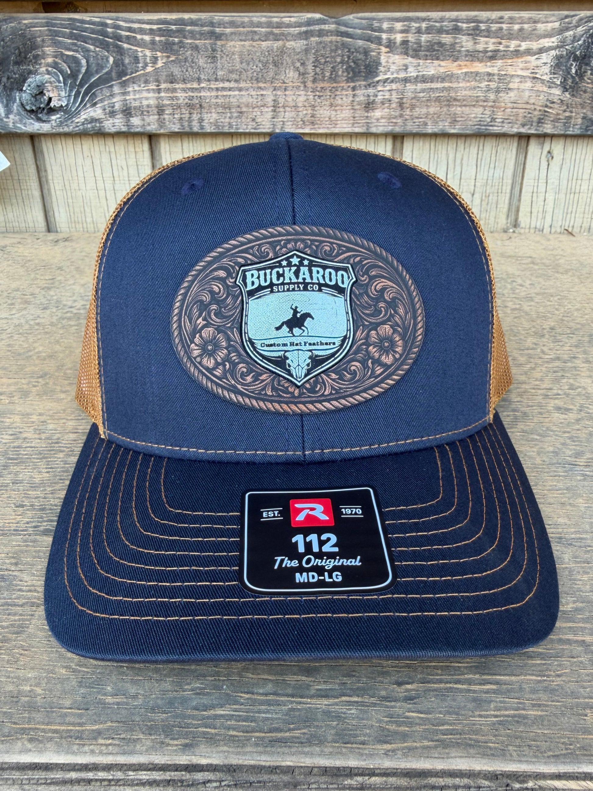 Blue trucker hat with a brand logo on a wooden surface