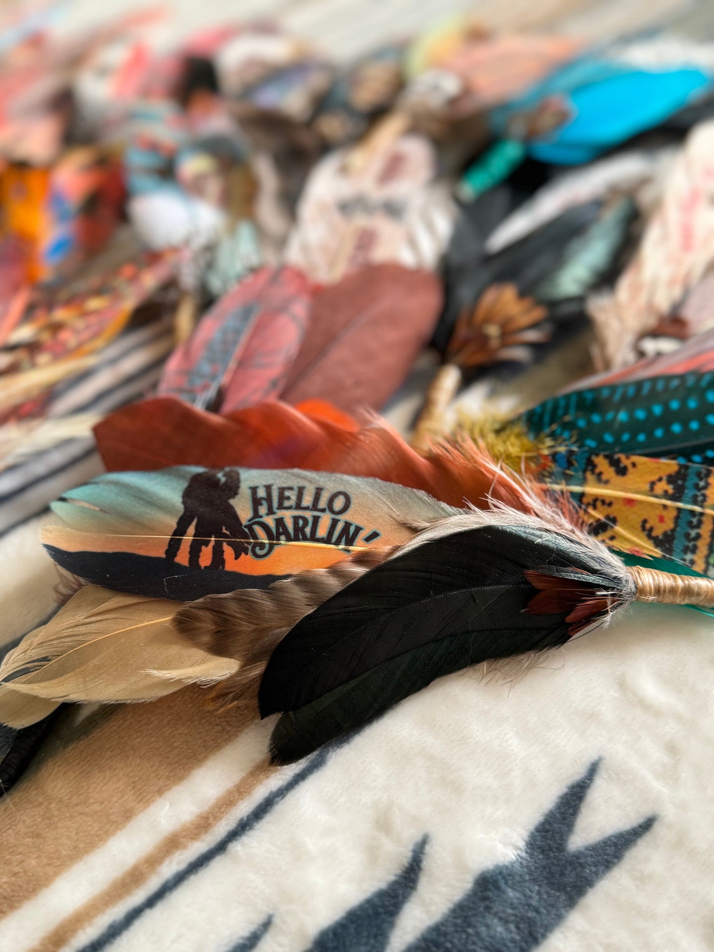 Soft turquoise cowgirl hat feather with Hello Darlin’ design