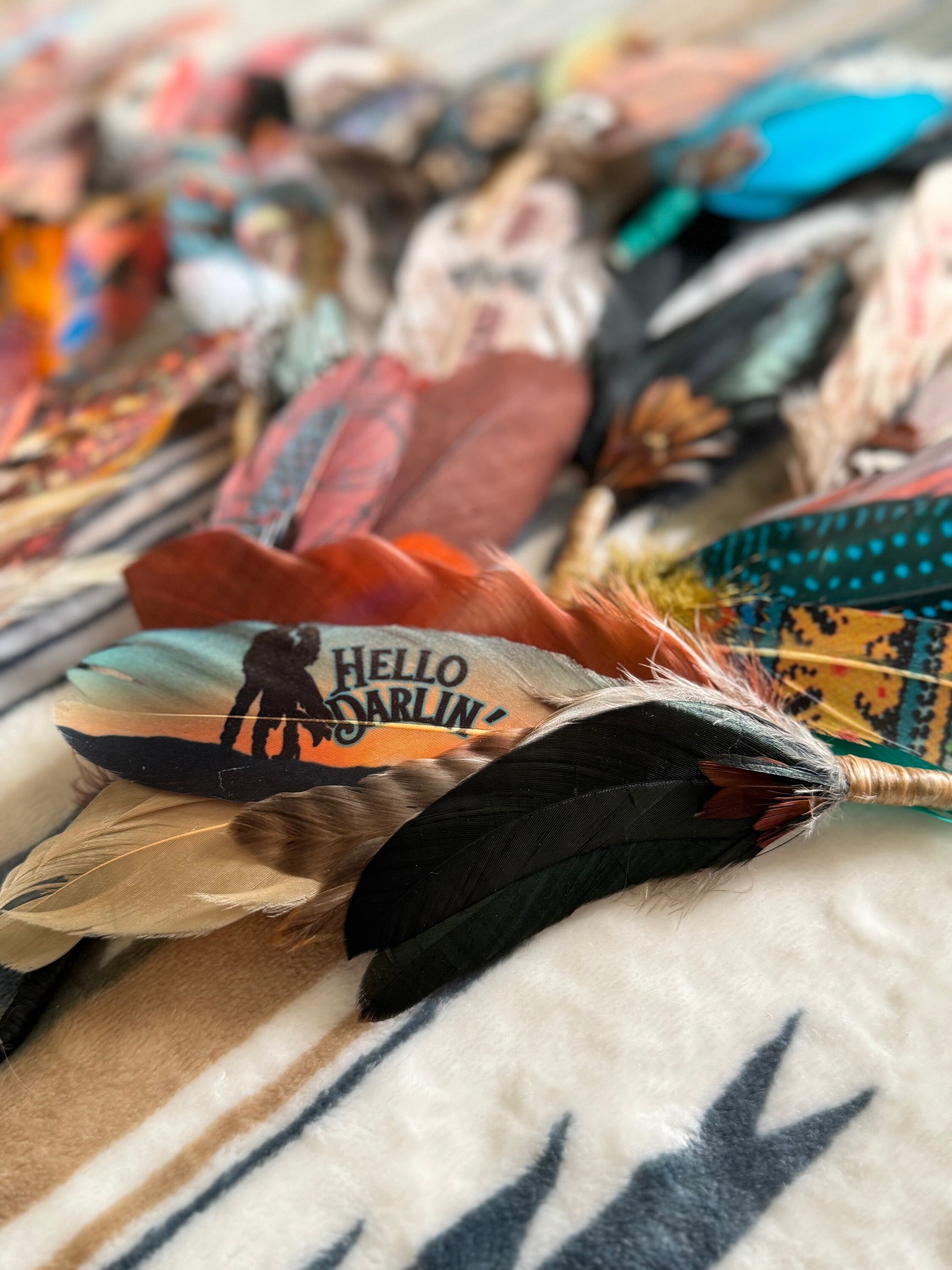 Soft turquoise cowgirl hat feather with Hello Darlin’ design