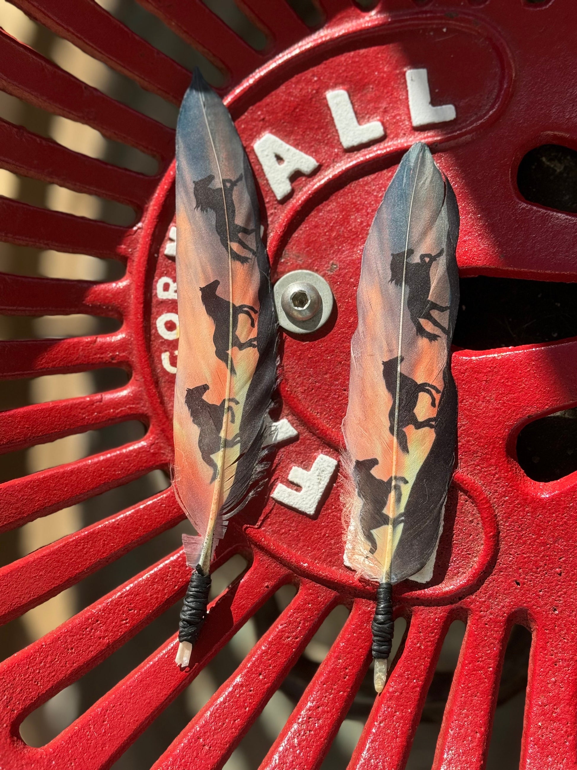 Two feathers with camouflage pattern on a red 