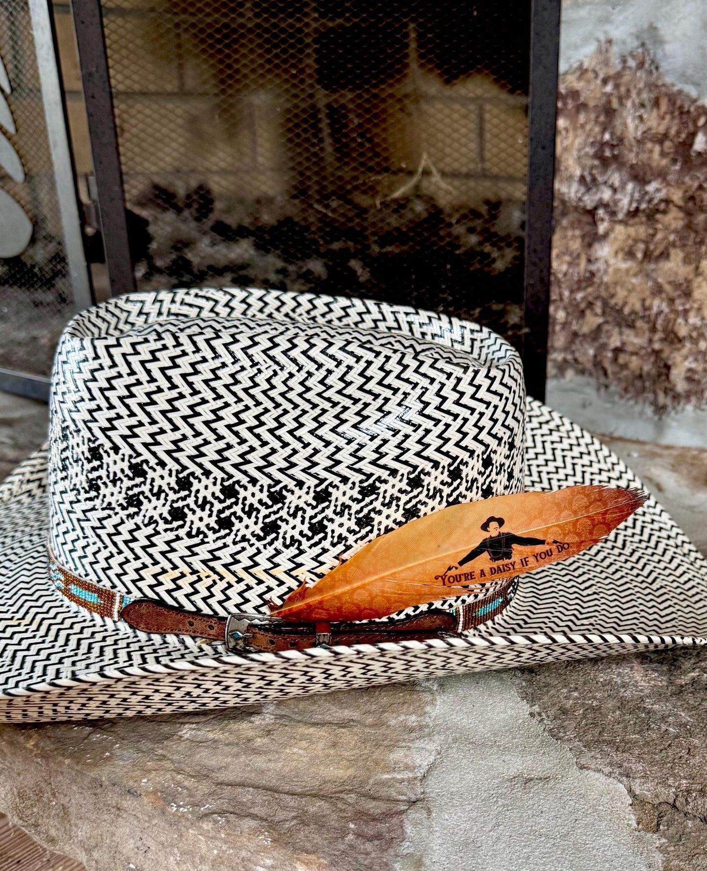 Golden cowboy hat feather with Western graphic design