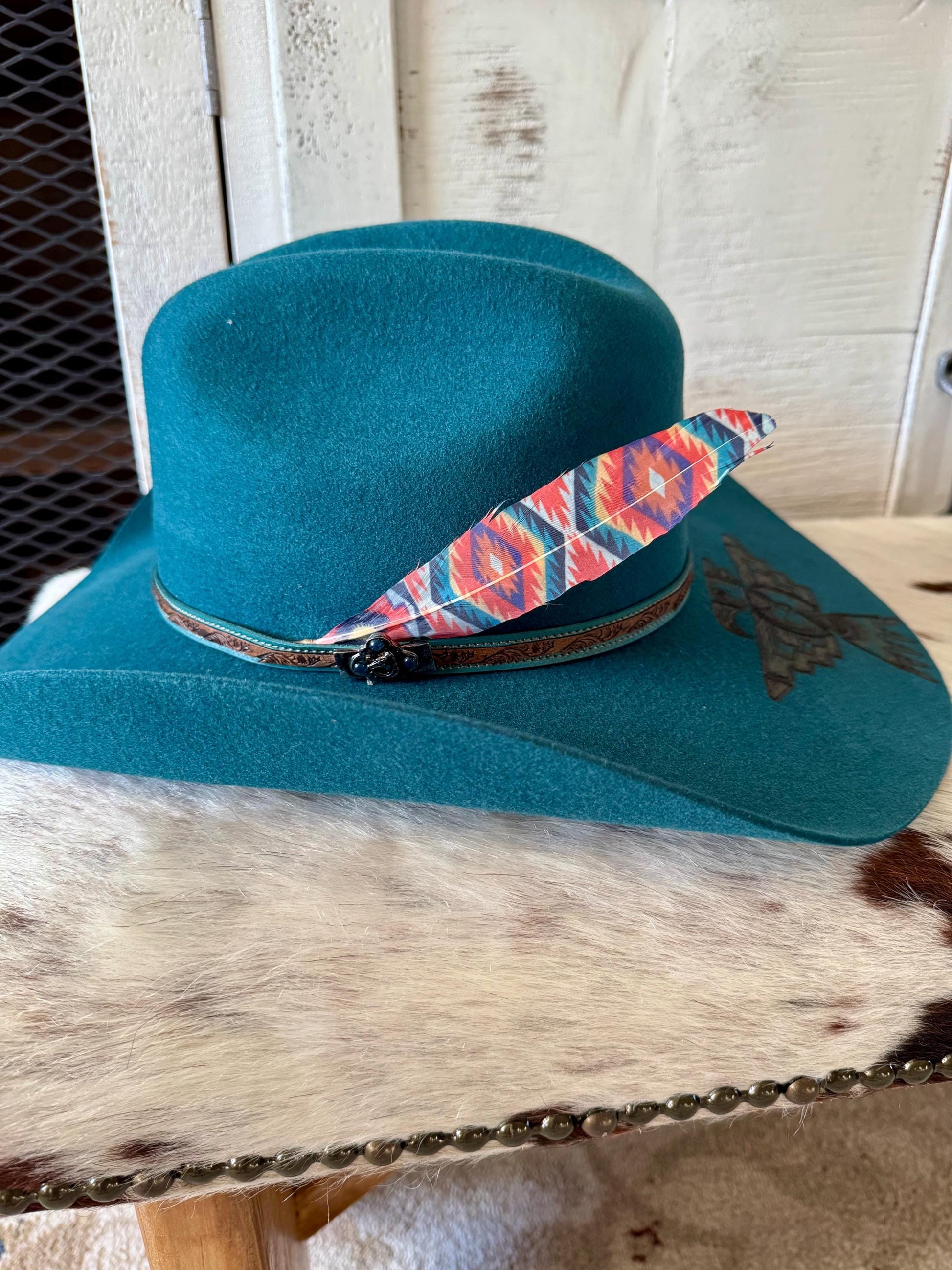 Southwestern geometric cowboy hat feather with turquoise coral and red tones