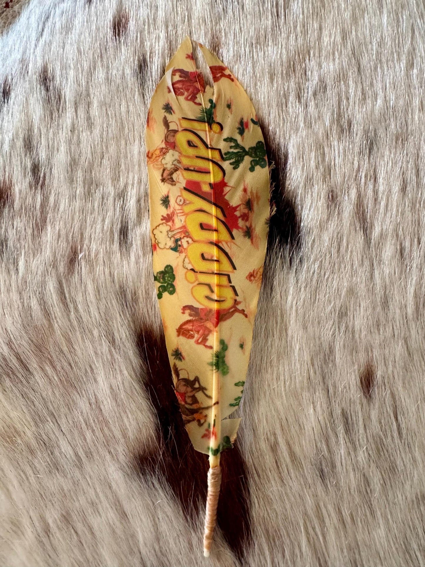 Decorative feather with colorful patterns on a textured surface