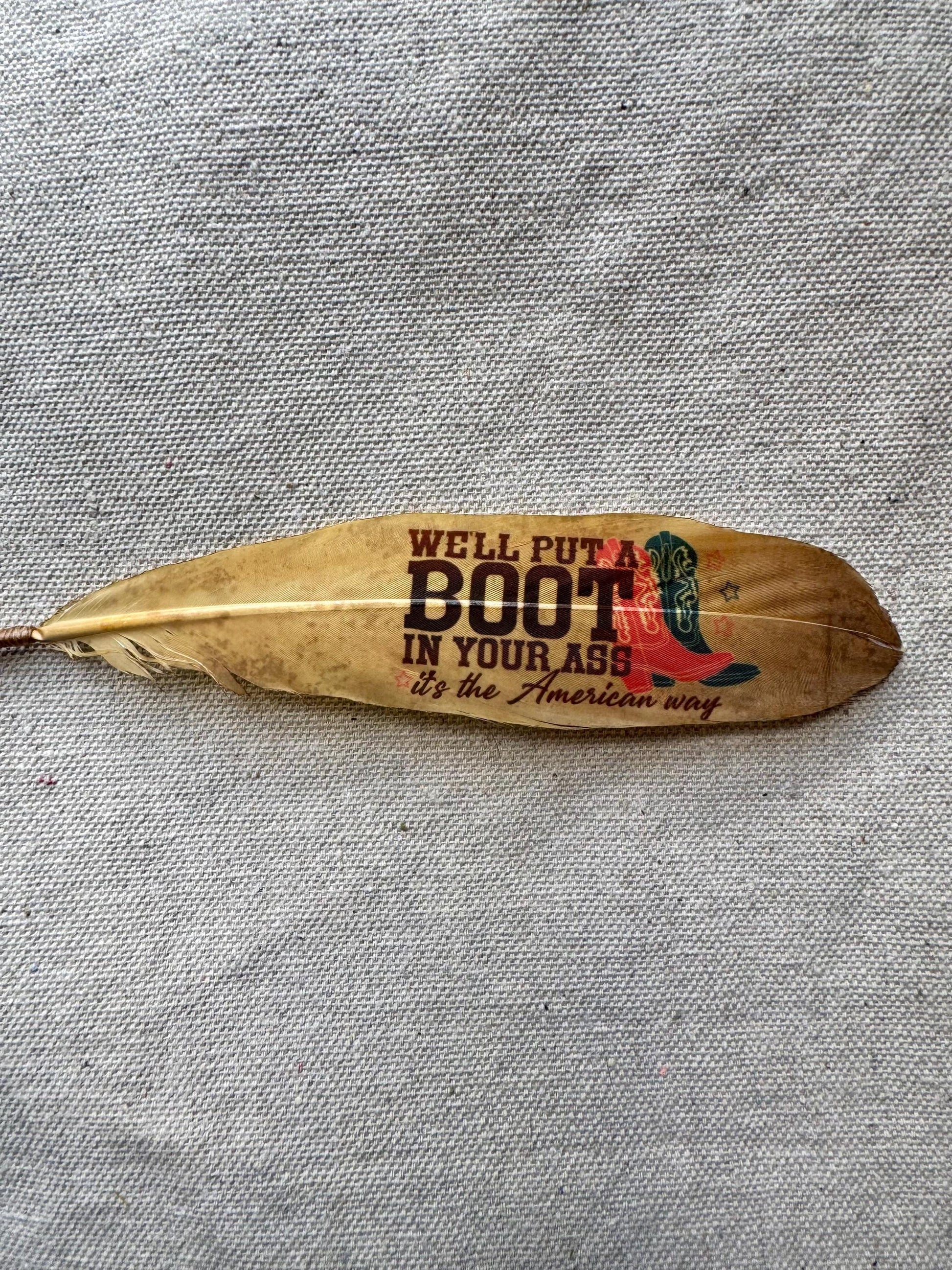 Feather with printed text and boot graphic on a textured fabric background