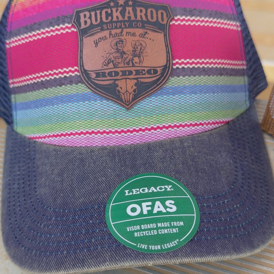 Colorful serape striped trucker hat with a Buckaroo Supply Co logo.